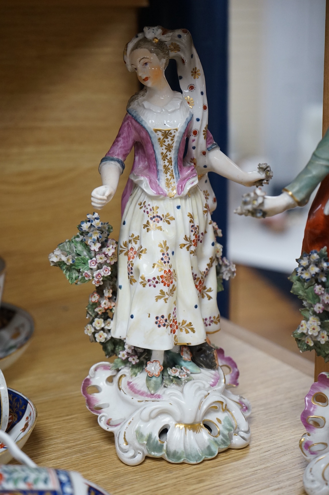A pair of 18th century Derby porcelain figures of a lady and gentleman, 27cm high